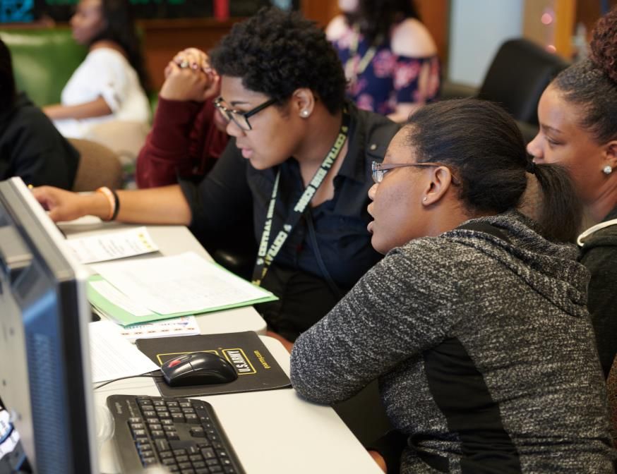 High school students working together at classroom computers