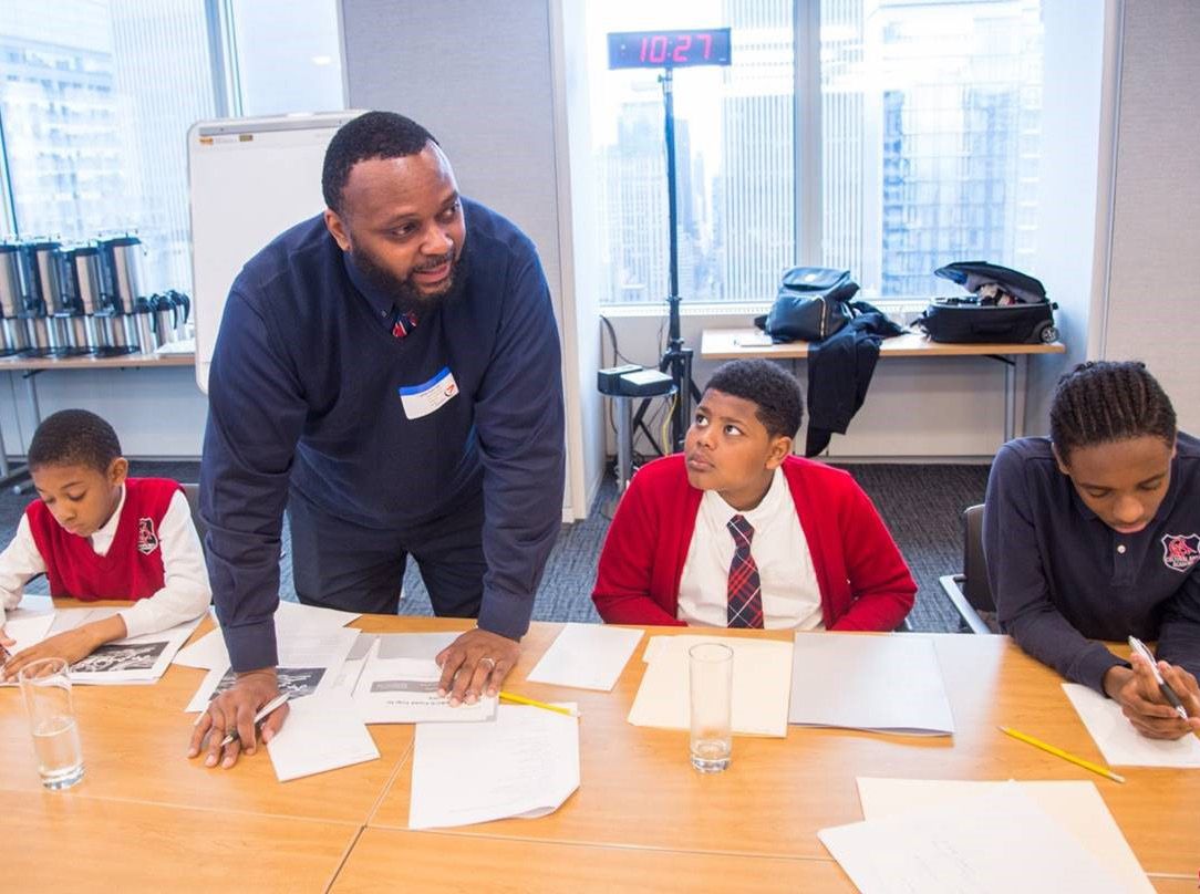 A volunteer helping students