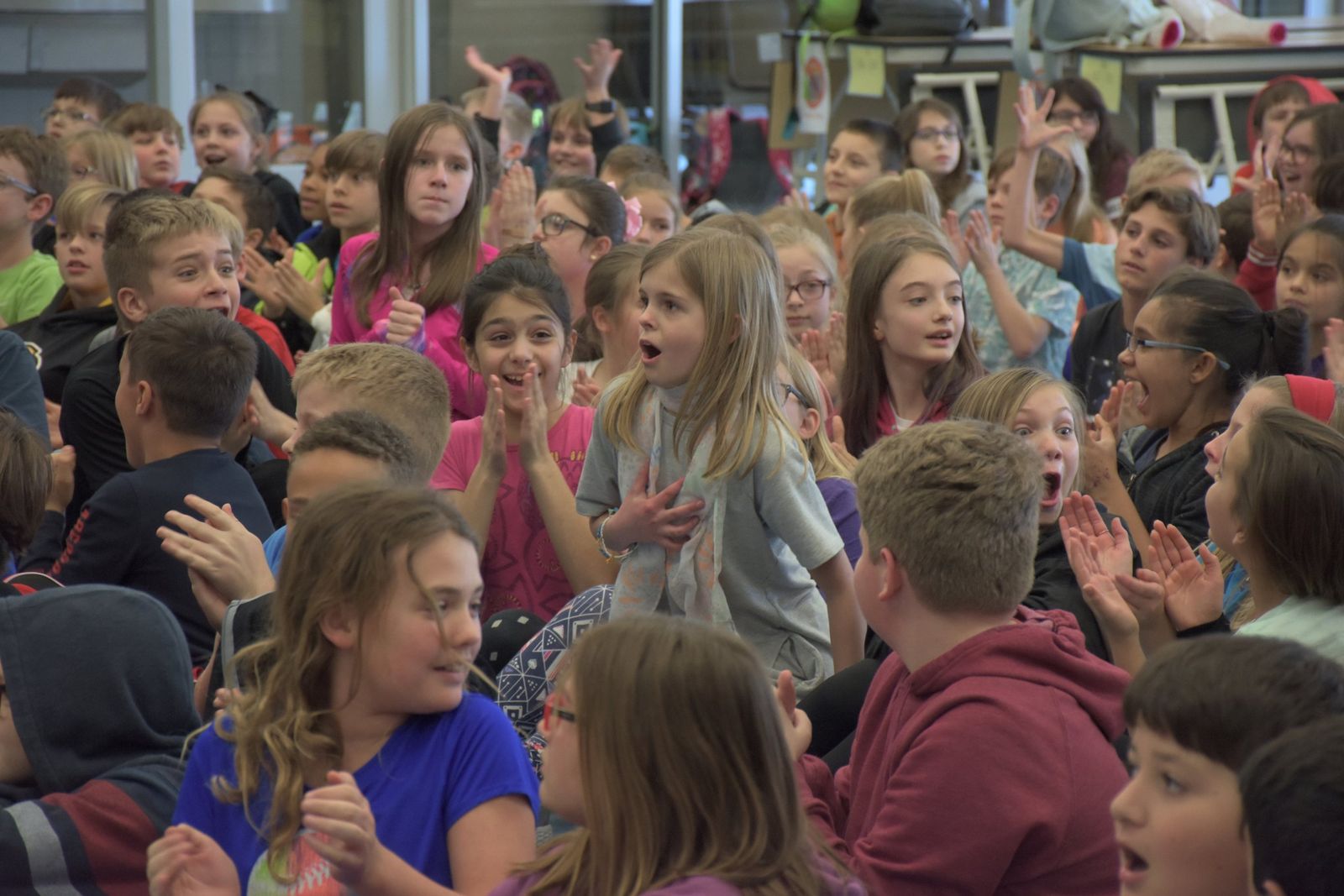 Elementary students cheering at a surprise winner announcement
